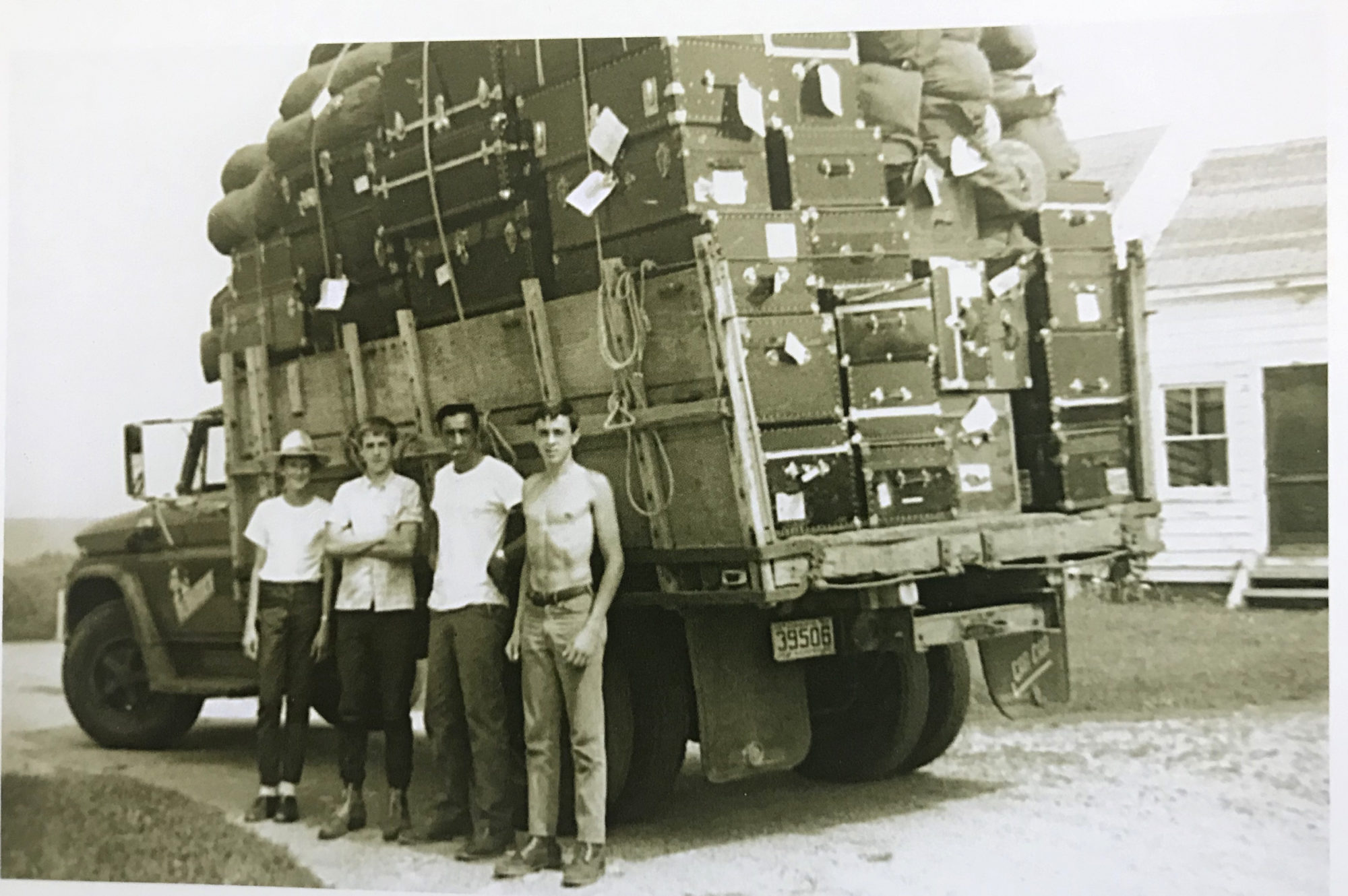 A black and white photo from the early days of Camp Pemi, showing a truck loaded with trunks