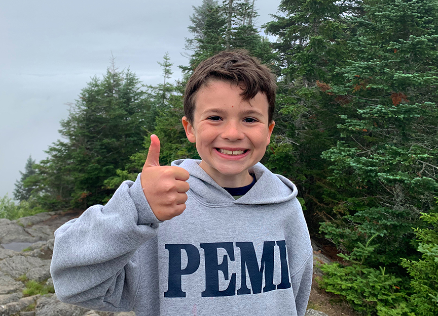 Camper with Pemi sweatshirt giving thumbs up