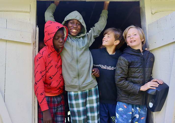 Pemi campers in junior cabin doorway