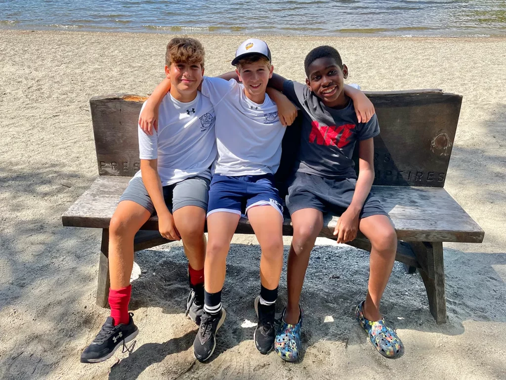 Three Pemi campers smiling at the camera