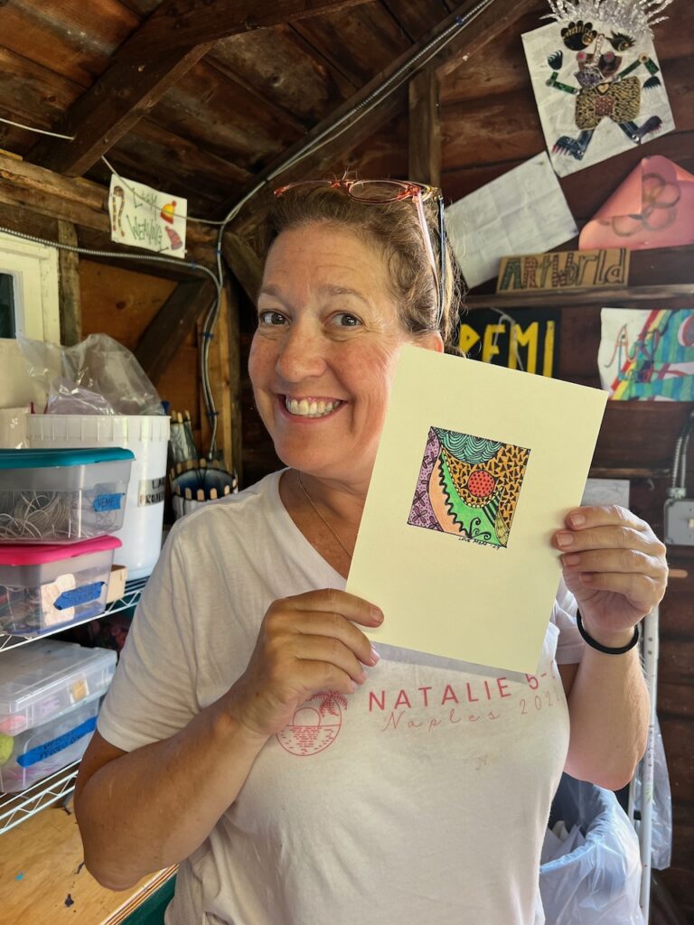 Woman holding her art project at Women's Weekend